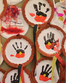 Hand paintings depicting the Aboriginal flag
