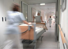 A fast moving shot of a patient being rushed down a hospital corridor